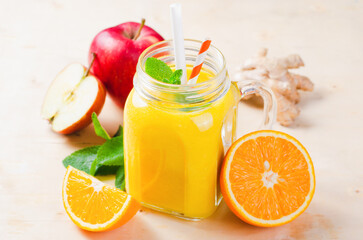 Fresh Smoothie with Orange, Apple and Ginger in a Glass Jar, Vitamin Drink, Detox, Cocktail on Bright Background