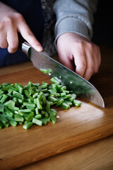 close up of a woman chef cutting beans