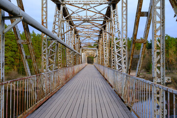 Naklejka premium The old railway bridge. Historic narrow gauge railway bridge. A popular walking spot in Valmiera, Latvia