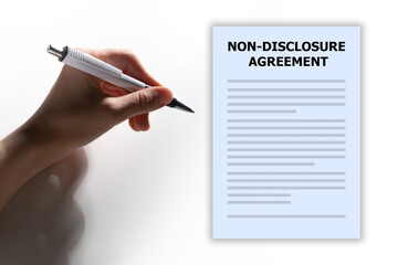 NDA contract. Hand signs document. Non-disclosure agreement. Agreement to protect confidentiality....