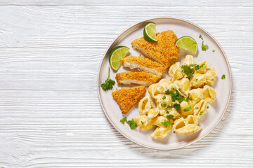 breaded chicken fillet with alfredo pasta shells