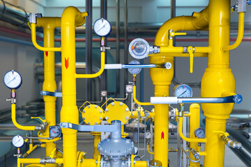 Gas equipment. Yellow pipes. Compressor station. Pipes with pressure sensors. Equipment for gas processing. Industrial gas equipment. Basement with yellow piping. Propane, methane. 
