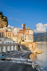Atrani, Italy. View of the small seaside village of Atrani and its beach, on the Amalfi Coast. In the distance the coast of Salerno. Vertical image. 2022-12-28.