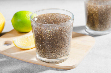 Chia Infused Water with Lemon, Healthy Citrus Drink on Bright Background