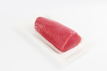 Fresh tuna on a white background. A piece of tuna on a platter. Healthy food. natural omega. Isolated object.Copy space.