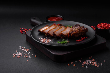 Delicious juicy pork steak on the bone with spices and herbs