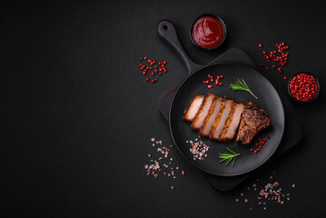 Delicious juicy pork steak on the bone with spices and herbs