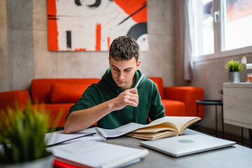 Young man caucasian teenager read book study at home education concept