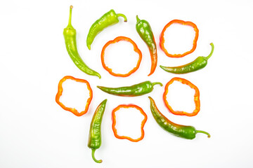 red sweet and green hot peppers on a white background. cooking vegetables for food