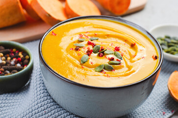 Sweet Potato Soup, Fresh Homemade Pumpkin, Sweet Potato, Carrot Soup in a Bowl on Bright Background