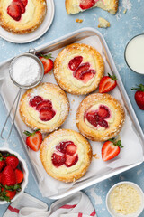 Brioche buns with strawberries, ricotta cream and vanilla streusel. Summer berry pastry. Top view