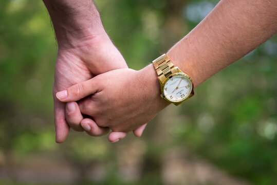 Couple in love, valentine's photoshoot, holding hands, golden champion watch