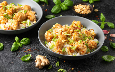 Kung Pao Cauliflower with rice, peanuts and spices. Healthy vegan food.