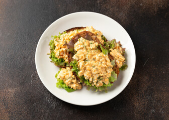 Egg salad sandwiches with greens and herbs on white plate. Healthy food.