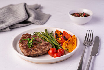 Food photography of roasted lamb steak, grilled, meat, fillet, green beans, paprika, cherry tomatoes