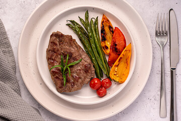 Food photography of roasted lamb steak, grilled, meat, fillet, green beans, paprika, cherry...
