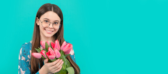 smiling child portrait in glasses with tulips. mothers or womens day. kid hold flowers. Banner of...