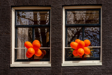 April 26, 2023, Amsterdam, Netherlands, Details of façade decoration for Kings Day, orange balloons