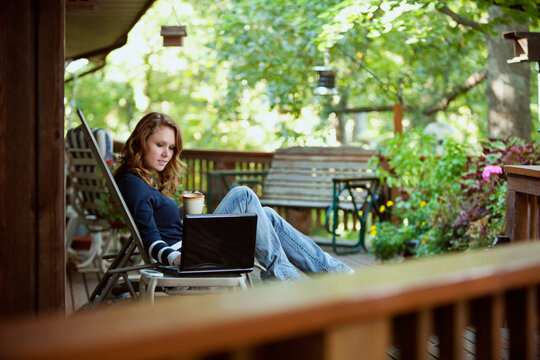 Working: Woman Relaxing While Checking Up On Business
