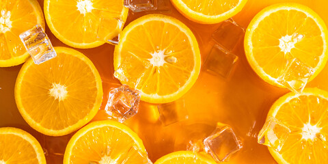 Orange slices and ice cubes with sparkling juice, fresh fruit lemonade with sparkling water and ice cubes, summer lemonade orange drink. Flat lay, top view