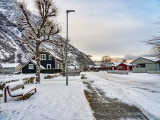 Eidfjord village street covered in snow during sunset, Norway