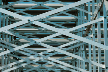 Looking up at metal pattern underneath bleachers