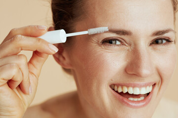 smiling woman with brow brush