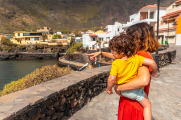 Fototapeta na wymiar A mother with son in the village of Tamaduste located on the coast of the island of El Hierro in the Canary Islands, Spain