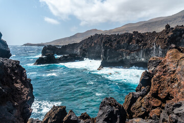 Views of the cliffs from the volcanic trail in the town of Tamaduste on the coast of the island of El Hierro, Canary Islands, Spain