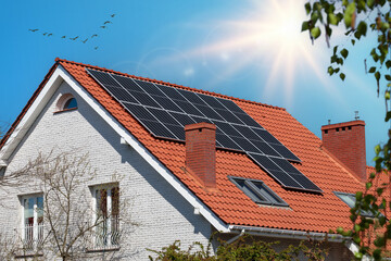 Roof of a modern house featuring solar panels.