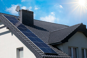 Solar panels installed on the roof of a modern house.