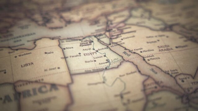 Egypt on a vintage political world map. Slow motion, tracking arc shot.  