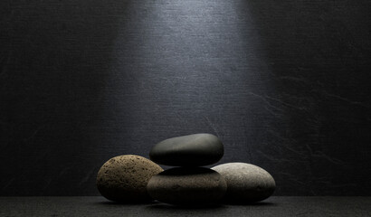 beautiful gray and black stones on a gray background for a podium background product presentation.zen stones with texture and shadows on a gray background.