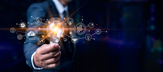 Man holding light bulbs, ideas of new ideas with innovative technology and creativity. technology business financial with light bulb technology. Big data digital connection on communication networks