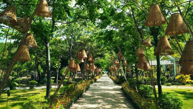 Ancient historical old complex. Culture A national architectural feature. Tropical park trees. visual journey. Park Dao Hoa Lai in city Nha Trang, Vietnam. 4K