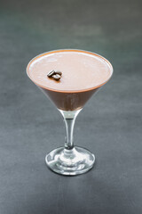Vegan dessert. Coffee Panna Cotta in a martini glass. Dark gray background