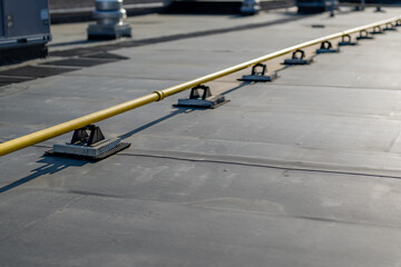 Photo of a yellow gas pipe on a new EPDM on a large commercial building © Thomas