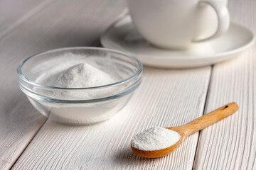 Herbal sweetener stevia in spoon and a cup of coffee