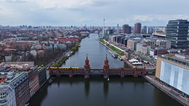 Drone shot of a train crossing The Oberbaum Bridge (Oberbaumbr&uuml;cke) it is a double-deck bridge crossing Berlin's River Spree, considered one of the city's landmarks. 