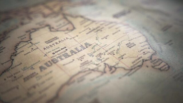 Australia on a vintage political world map. Slow motion, tracking arc shot. 