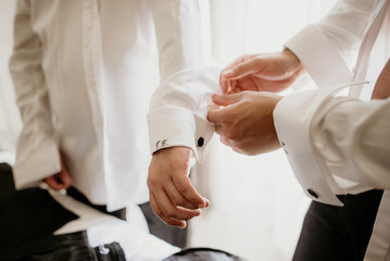 bride and groom getting ready for wedding day holding hands wedding day ring bouquet with flowers in white wedding dress marriage pink robes slippers 