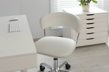 Stylish office chair at workplace in room. Interior design