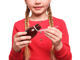 Cute girl pouring syrup from bottle into dosing spoon on white background, closeup