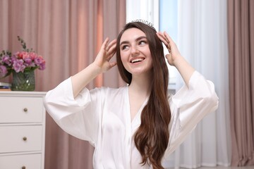 Naklejka premium Beautiful young woman in headband in room. Happy Birthday