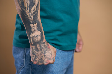 Cropped view of unrecognizable man hand with black tattoo