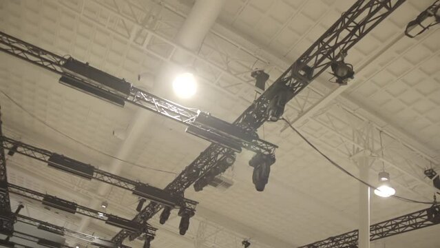 Low shot of a construction for an event to hang party lights on in slowmotion LOG