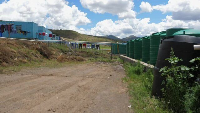 Large cisterns collect rainwater at Polihali Dam construction camp