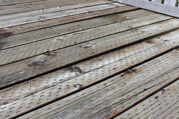 Weathered and warped wood deck surface 