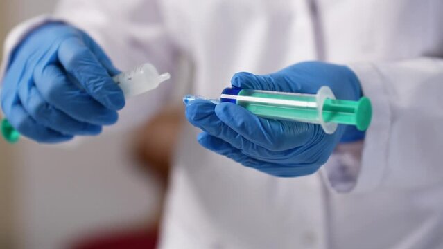 Slow motion shot of two syringes being connected to each other - pta learning clips
