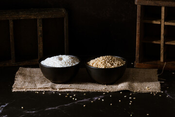 Black bowls with white yamani rice and brown yamani rice.